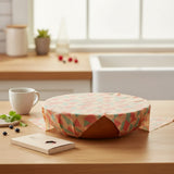 SuperBee Australia extra large beeswax wrap with retro geometric pattern covering a wooden bowl in a kitchen