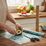 SuperBee Australia beeswax wrap roll with dog print being cut to wrap an avocado in a sustainable kitchen setting
