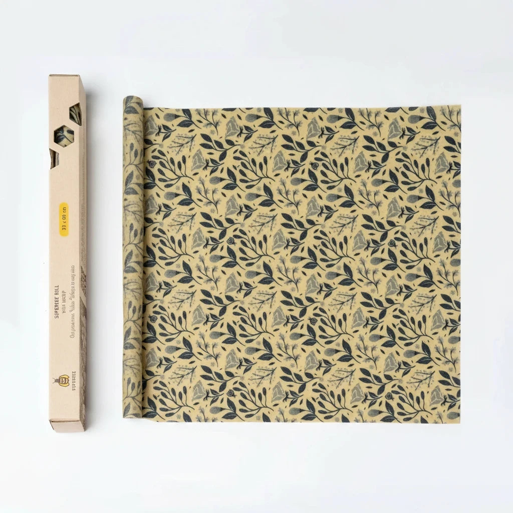 SuperBee Australia beeswax wrap roll with a petite flower pattern in yellow and dark grey, next to its cardboard box.