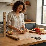 SuperBee Australia beeswax wrap roll with octopus print being used by a woman to cover a bowl in a kitchen.