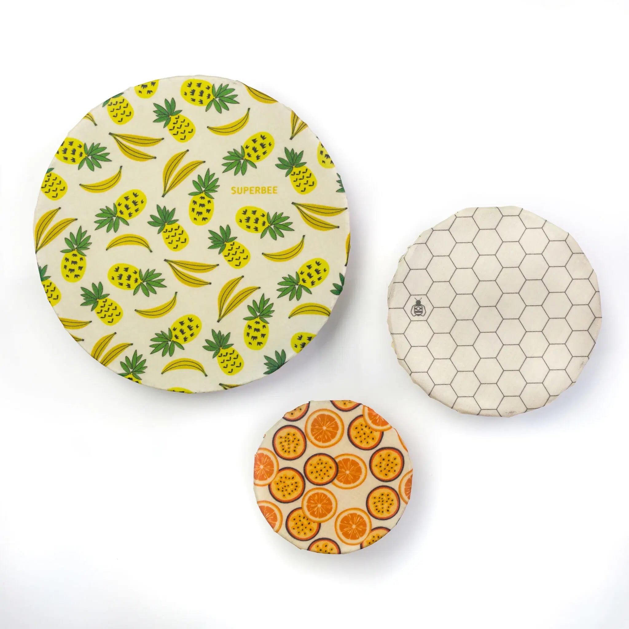 SuperBee Australia beeswax wrap set featuring pineapple, banana, honeycomb, and citrus fruit patterns on cotton.