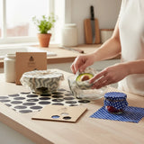 SuperBee Australia beeswax wrap Beeginner set with patterned cotton wraps covering glass bowls and jars in a kitchen.