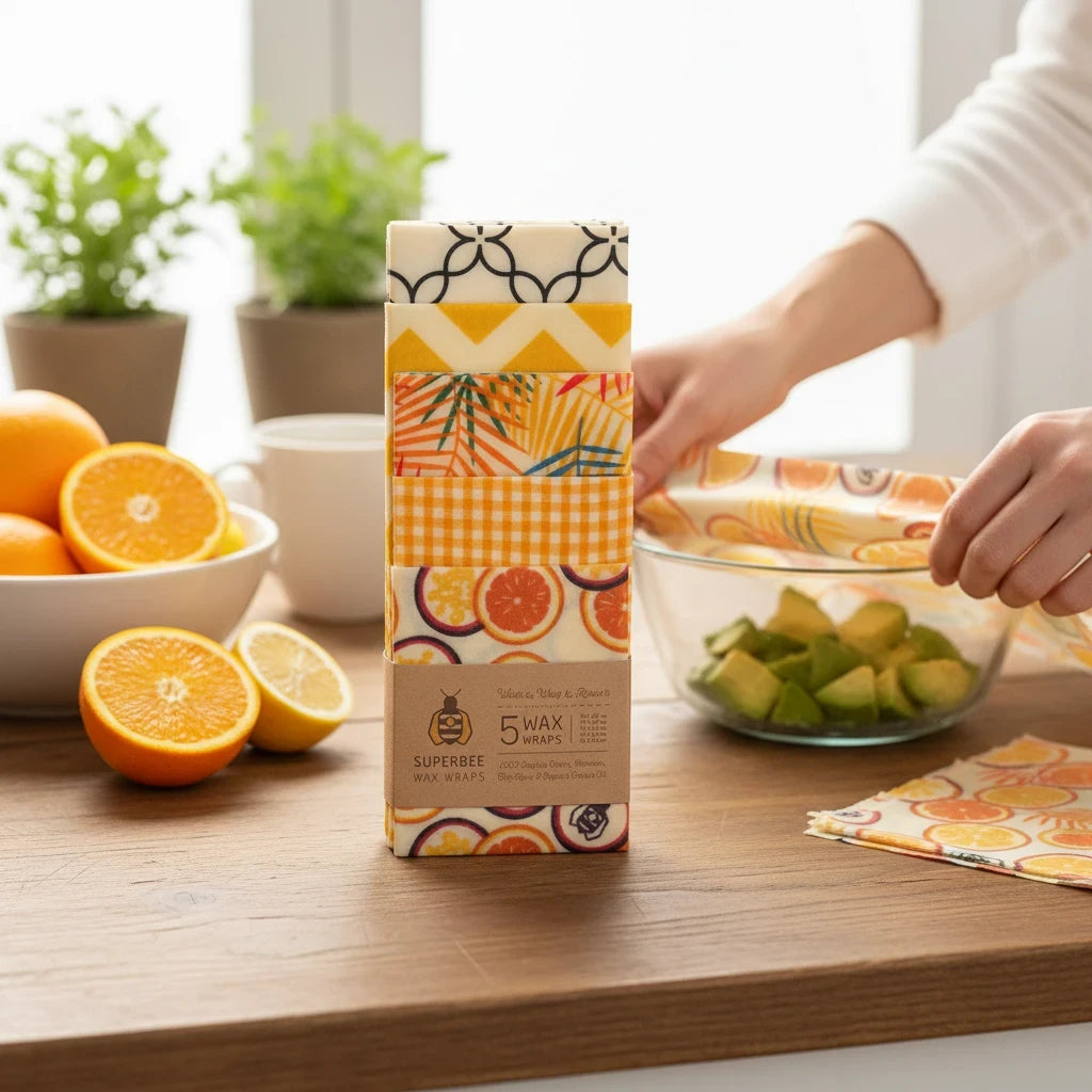 SuperBee Australia 5-pack beeswax wraps with assorted colorful fruit and geometric prints on a wooden kitchen table