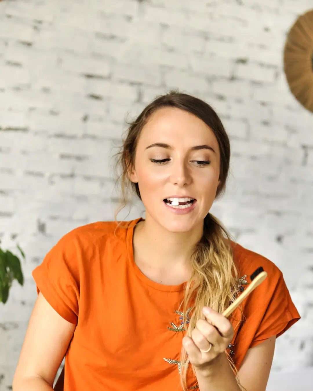 SuperBee Australia Dentos toothpaste tablet placed on teeth before brushing with a bamboo toothbrush