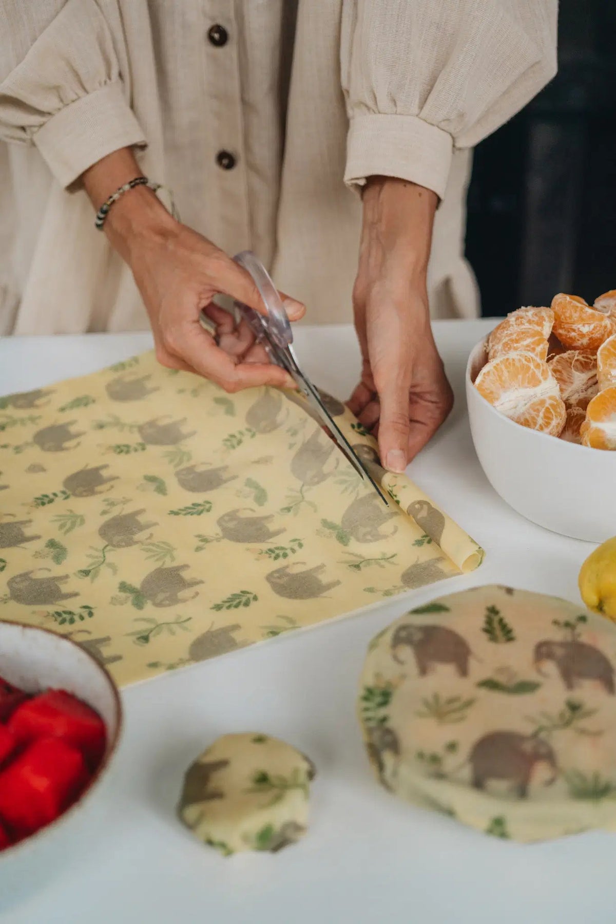 SuperBee Australia beeswax wrap roll with elephant print being cut with scissors for sustainable food storage