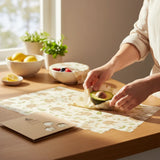 SuperBee Australia beeswax wrap Beeginner set with elephant print, used to wrap half an avocado on a wooden table.