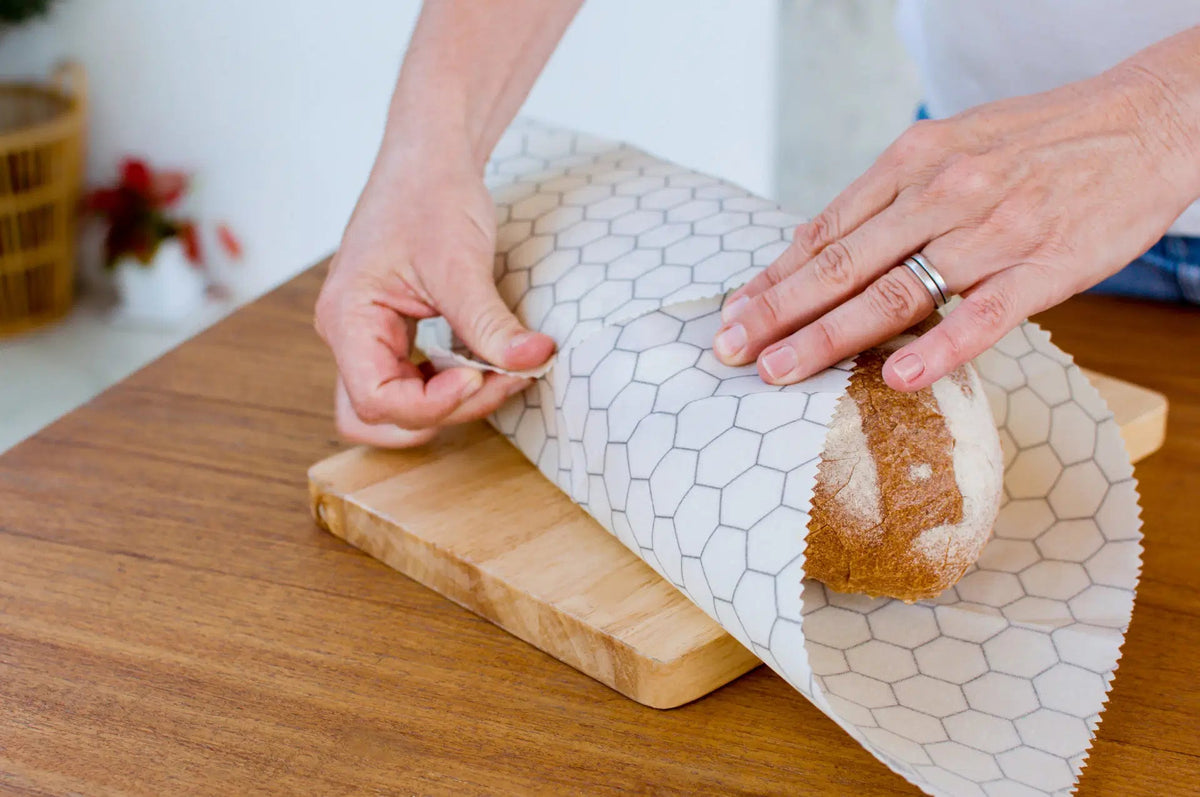 SuperBee Australia extra large beeswax wrap with a white and grey hexagon pattern wrapping a loaf of bread