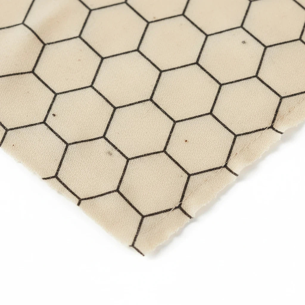 SuperBee Australia extra large reusable beeswax wrap in a beige fabric with a black hexagonal honeycomb pattern.