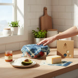 SuperBee Australia indigo beeswax wrap covering a bowl of fruit on a kitchen counter with a matching gift box.