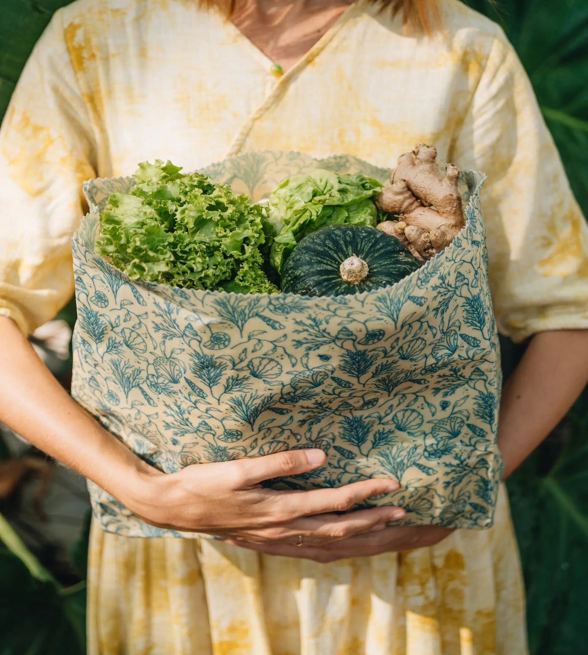 SuperBee Australia large reusable beeswax food storage bag in Sea Floor print filled with fresh produce
