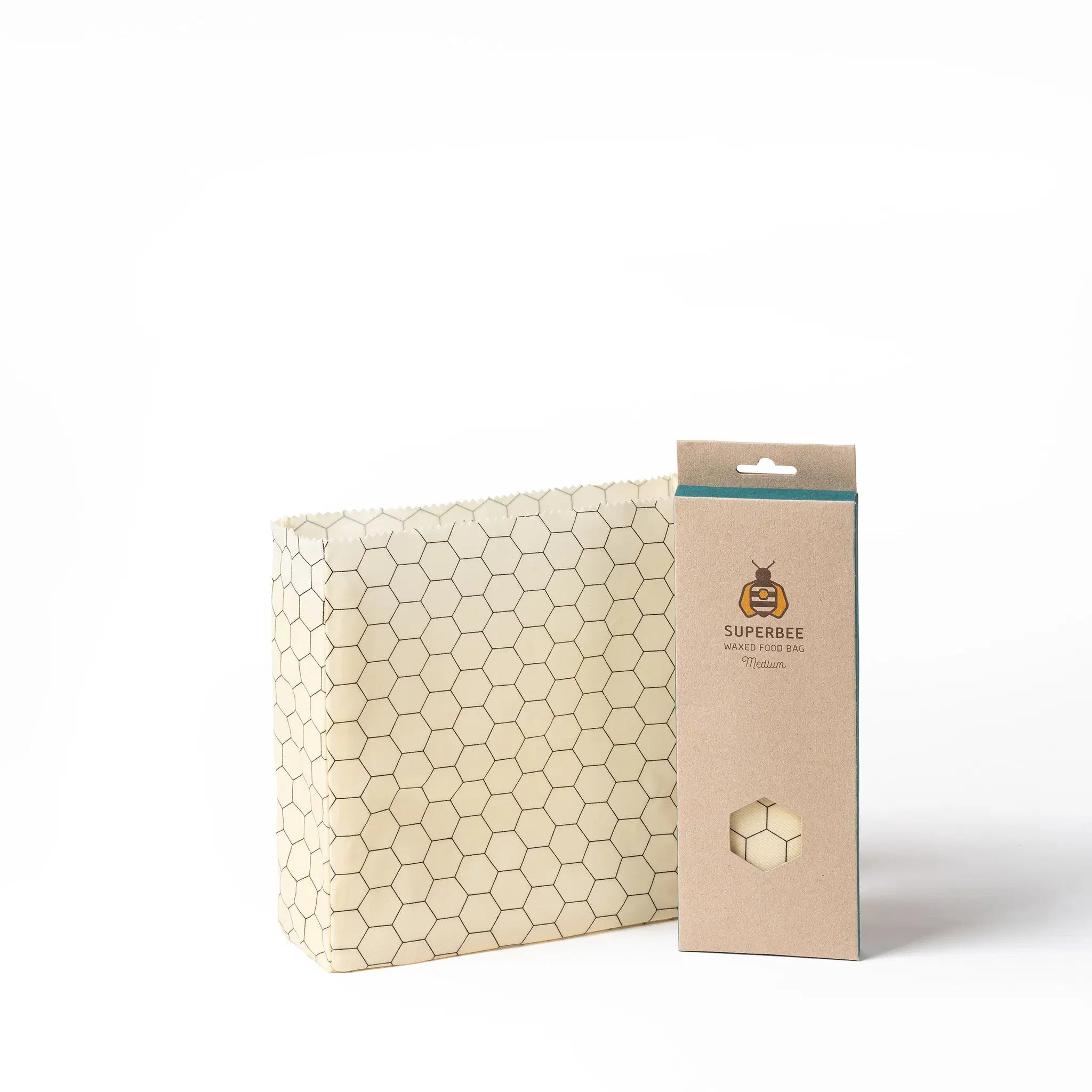 SuperBee Australia medium reusable beeswax food storage bag with a cream and black hexagonal pattern next to packaging