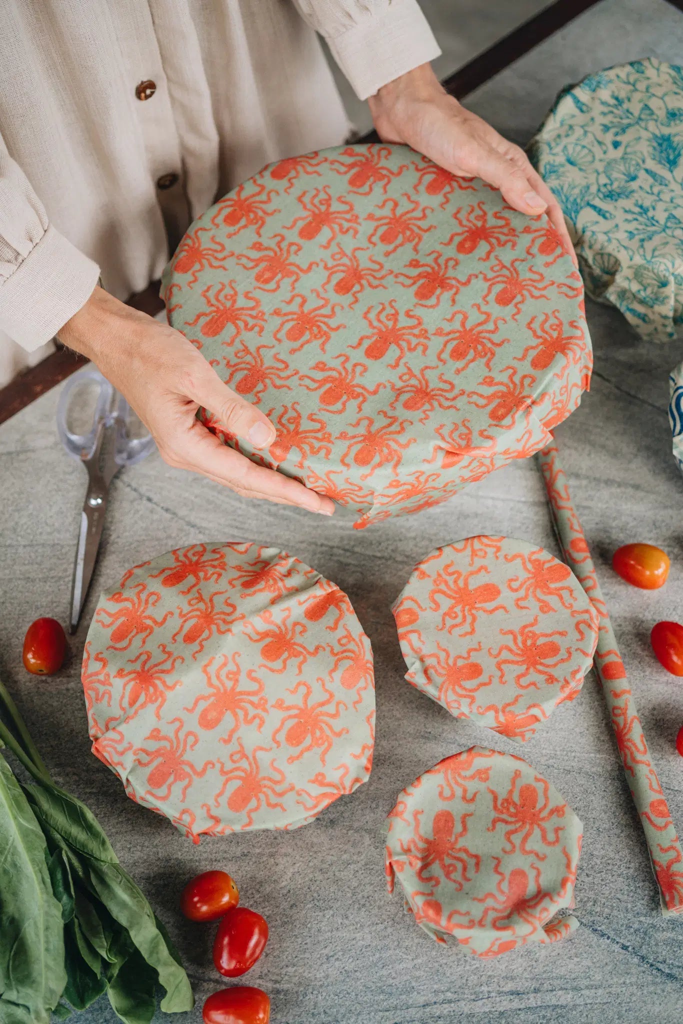 SuperBee Australia reusable beeswax wrap roll with orange octopus pattern covering bowls of various sizes