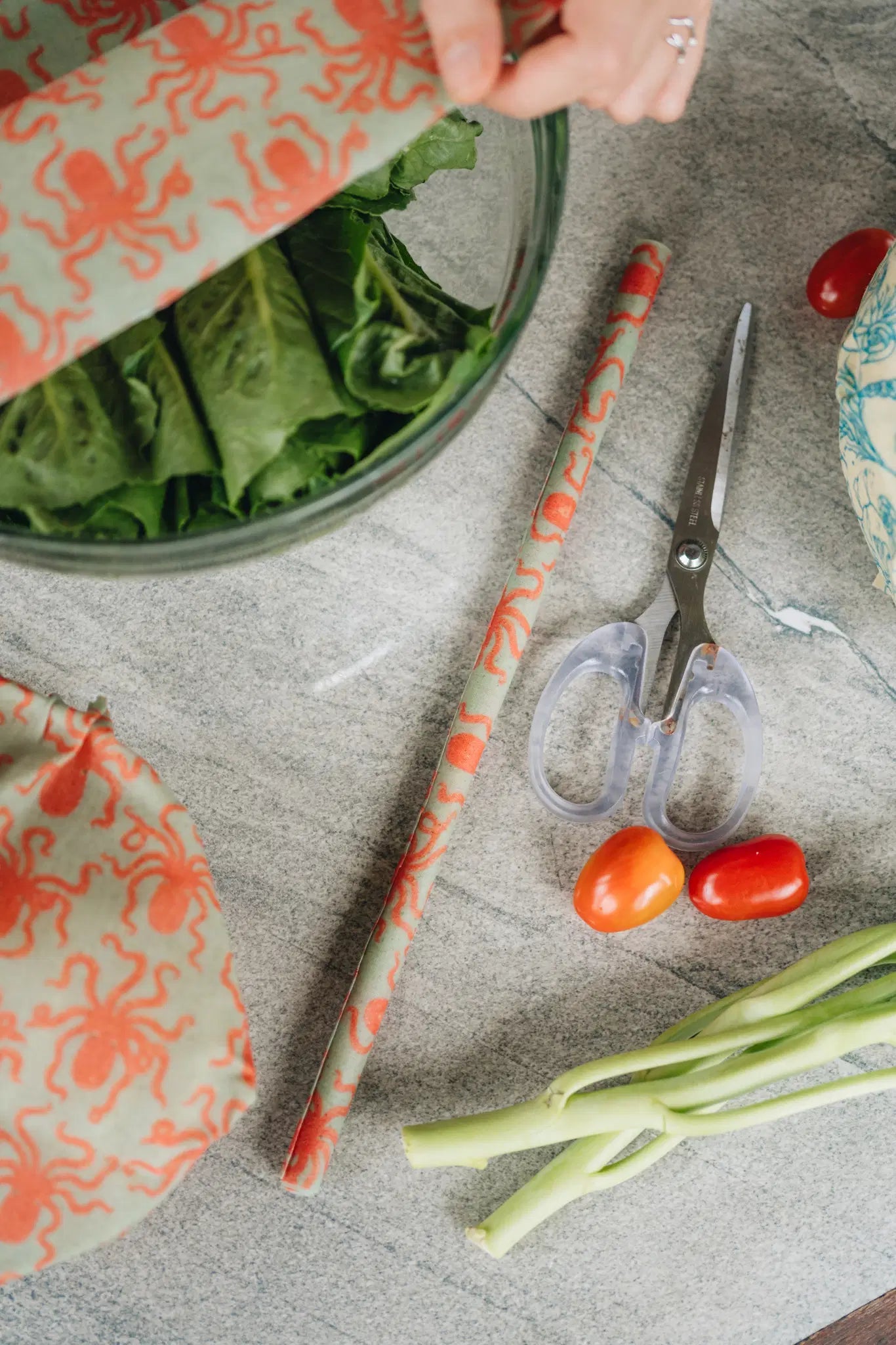 SuperBee Australia beeswax wrap roll with orange octopus print being cut to size for kitchen food storage