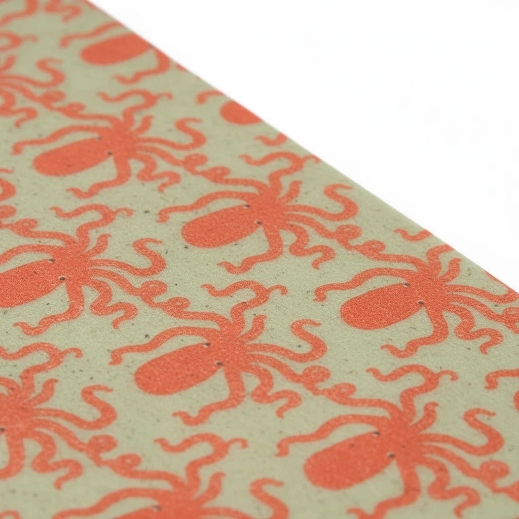SuperBee Australia reusable beeswax wrap roll featuring a repeating orange octopus pattern on a sage green background.