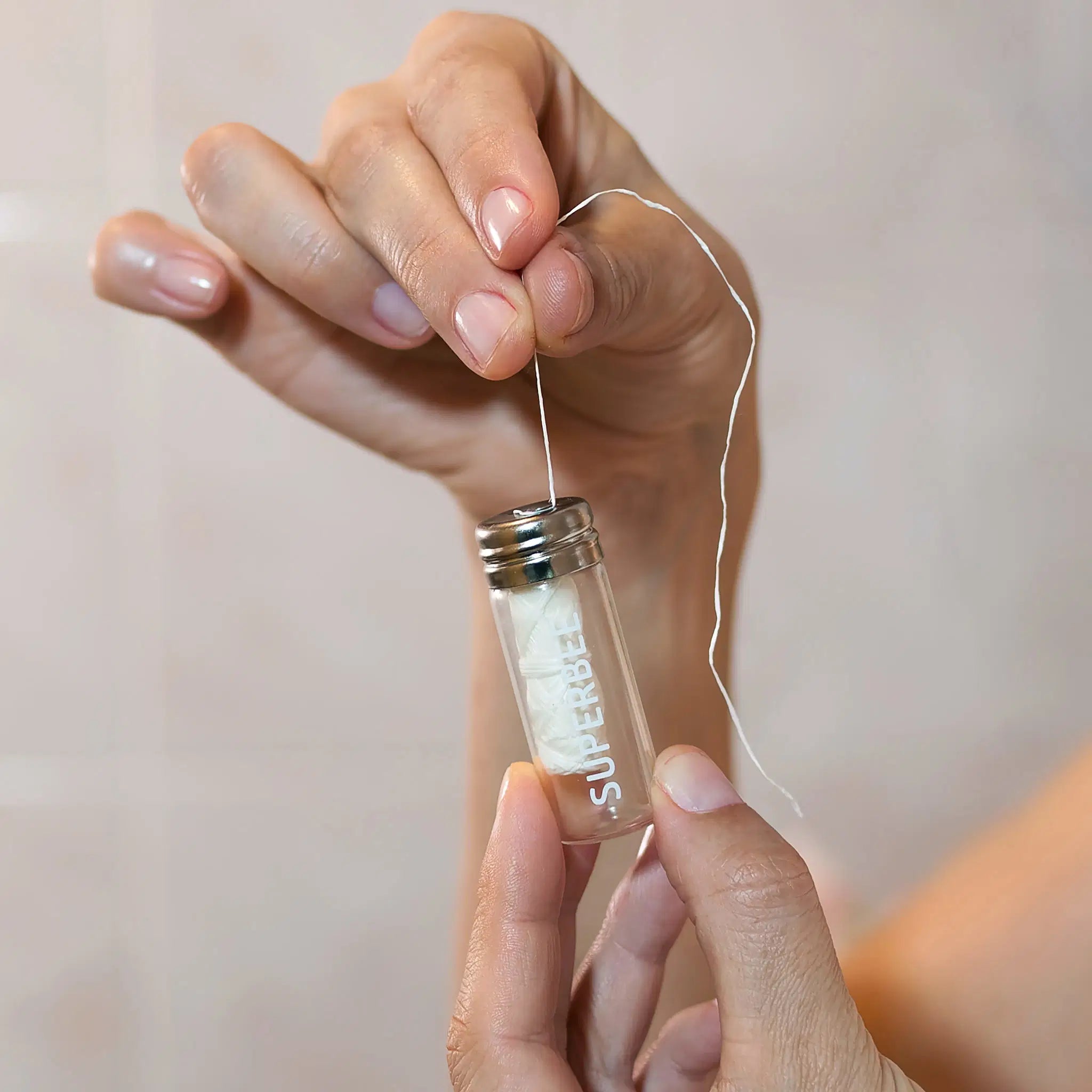 SuperBee Australia plastic-free dental floss made from organic corn fibre in a refillable glass vial