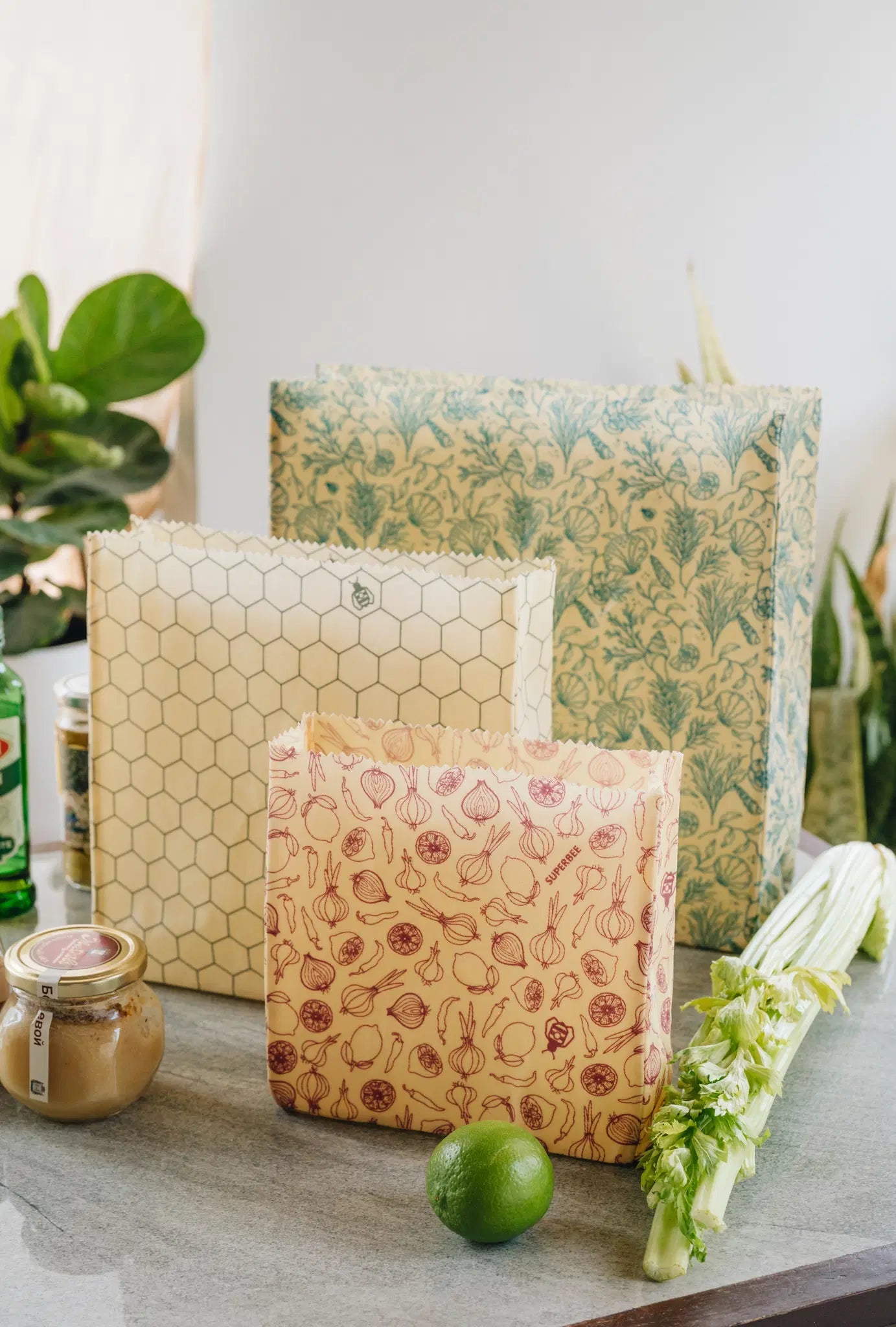 SuperBee Australia reusable beeswax food storage bags in small, medium, and large sizes with assorted floral prints.