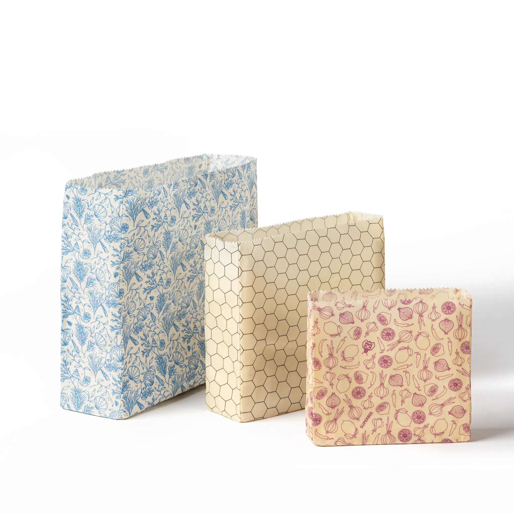 SuperBee Australia reusable beeswax food storage bags in small, medium, and large sizes with assorted patterns.