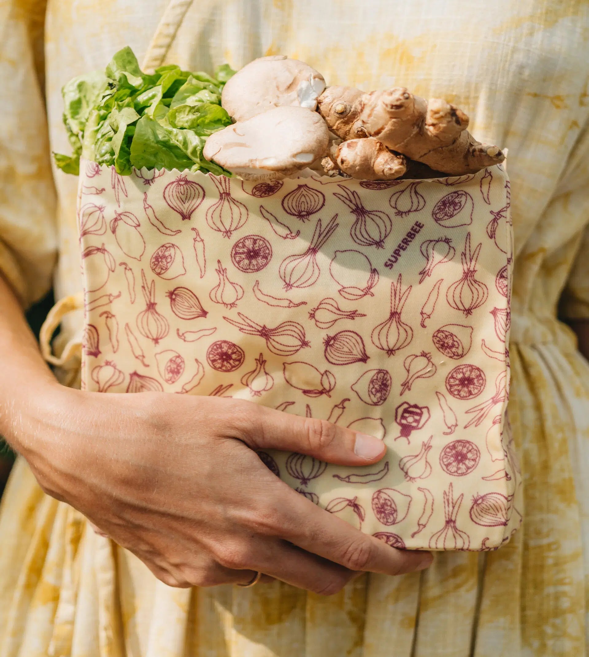 SuperBee Australia small reusable beeswax food bag with spicy vegetable print holding fresh produce